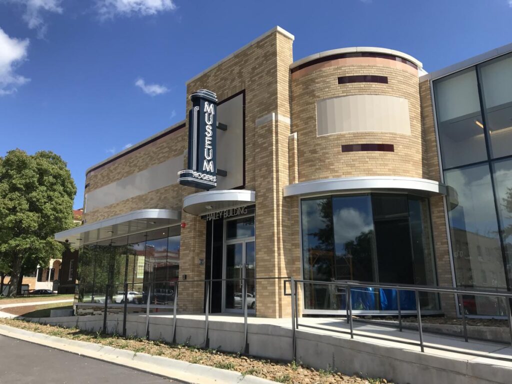 the exterior of a building with a sign on it.