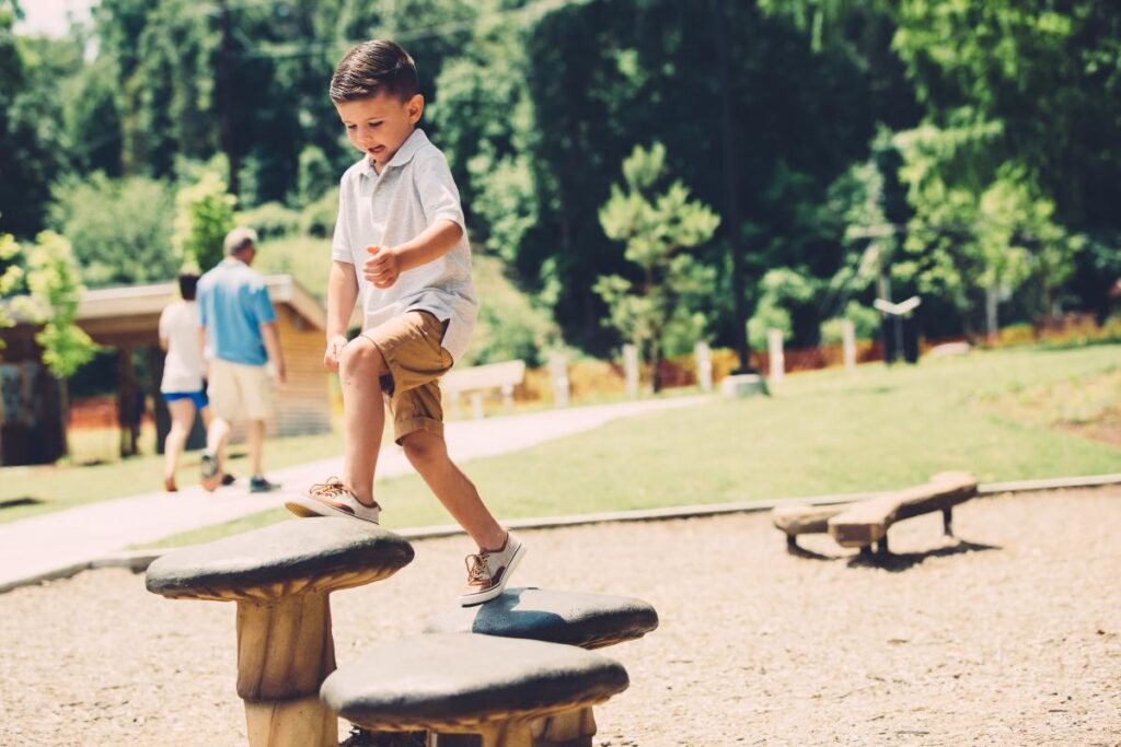 little boy playing at a park